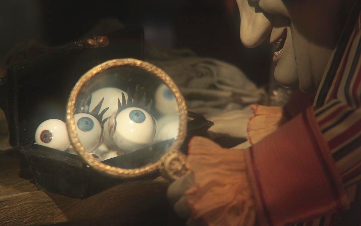 Титульное изображение для страницы события: кадр из фильма «Гофманиада», мужчина смотрит в лупу на сундук со стеклянными глазами