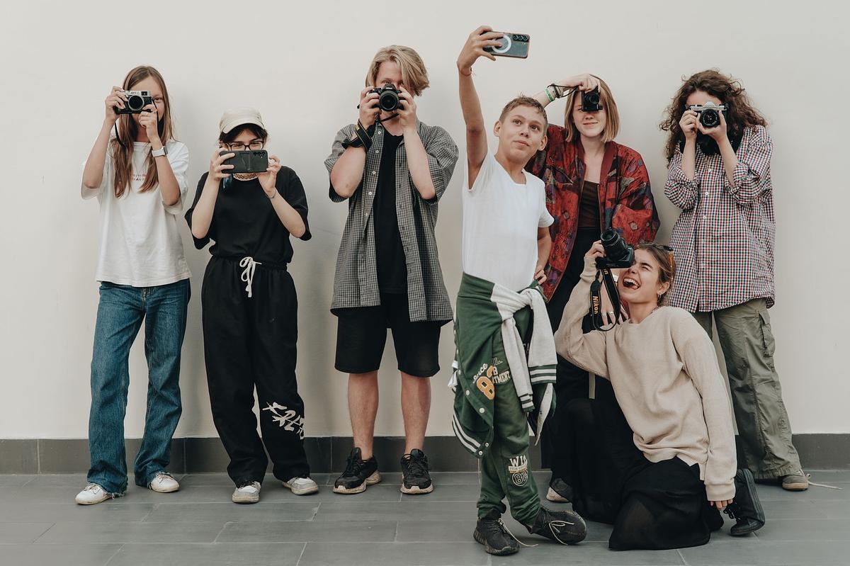 Группа подростков фотографирует