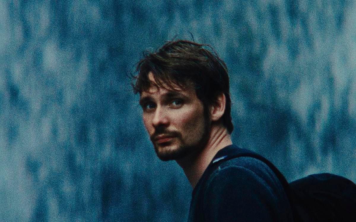 Кадр из фильма «Перел и доломит», мужчина с рюкзаком на размытом фоне