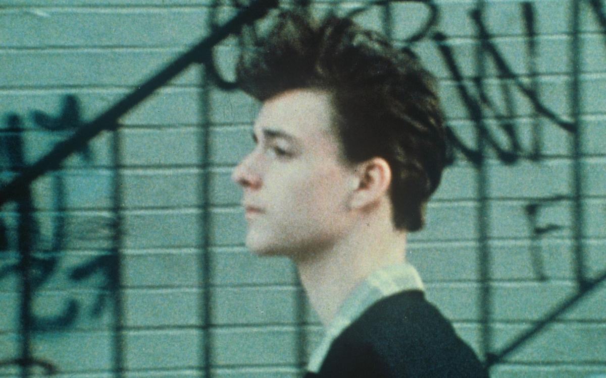 Кадр из фильма «Отпуск без конца», парень в профиль на против графити на стене